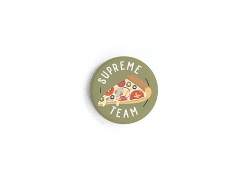 The Supreme Team Pizza Button Magnet by Onderkast Studio features a vibrant supreme pizza slice with SUPREME TEAM curved around it on a green background, printed in high-quality colors.