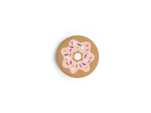 The Onderkast Studio Sprinkle Donut Button Magnet features pink icing and colorful sprinkles, shown from above on a white background—perfect for donut lovers.