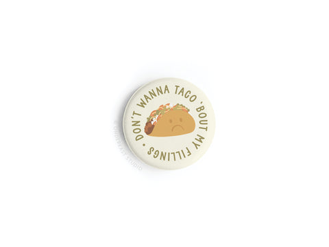 The Don’t Wanna Taco ‘Bout It Button Magnet by Onderkast Studio features a sad taco and the playful phrase “DON’T WANNA TACO ‘BOUT MY FEELINGS” on a white background—perfect for taco fans.
