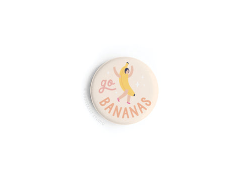 The Go Bananas Button Magnet by Onderkast Studio features a whimsical banana costume illustration and playful go BANANAS text, with vibrant colors and star accents on a light beige background.