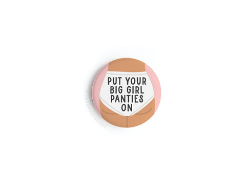 The Put On Your Big Girl Panties Button Magnet by Onderkast Studio features a bold illustration and uplifting message on a crisp white background—an empowering accessory and high-quality magnet for women.