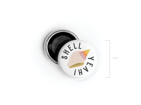 The Shell Yeah Button Magnet by Onderkast Studio features a pink and beige seashell and “SHELL YEAH!” on a round white 1.25 button—ideal for beach lovers. The open back reveals the black magnet inside.
