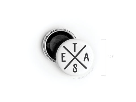 The Onderkast Studio Texas Logo Button Magnet features black intersecting lines forming an X with E, T, A, and S in each section. The round white 1.25-inch magnet is shown next to its open case with a black back.
