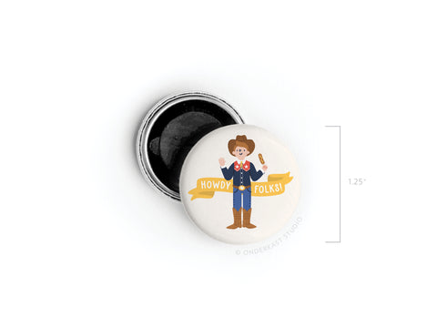 The Howdy Folks! Button Magnet by Onderkast Studio shows a smiling child dressed as a cowboy with a lasso and yellow Howdy Folks! banner, inspired by Big Tex and the State Fair of Texas. Measures 1.25 wide and has an open back revealing the black interior.