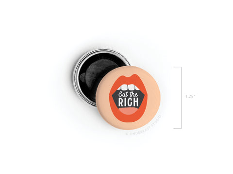 The Eat the Rich Button Magnet by Onderkast Studio is a 1.25-inch round pin-back featuring bold “Eat the Rich” text and a striking open mouth with red lips—perfect for making an economic justice statement.