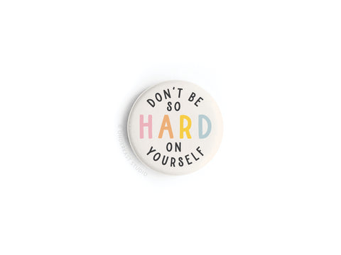 The Don’t Be So Hard On Yourself Button Magnet by Onderkast Studio features “hard” in bold, colorful letters and the rest of the phrase in black on a white background. Made in the USA, it’s a daily reminder for self-compassion.