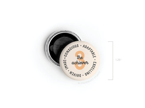 The Onderkast Studio Enneagram Button Magnet – 3 The Achiever features The Achiever at the center, with Type 3 traits—Image-Conscious, Adaptable, Excelling, Driven—around the edge. It measures 1.25 inches and has a black interior when open.