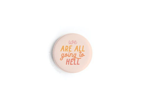 The Onderkast Studio We Are All Going to Hell Button Magnet is round, light pink, and features bold yellow, orange, and pink text on white—a playful magnet that adds quirky style to your space.