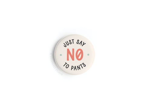 The Just Say No to Pants Button Magnet by Onderkast Studio features bold black and red lettering on a round beige magnet—ideal for anyone who loves a pants-free lifestyle.