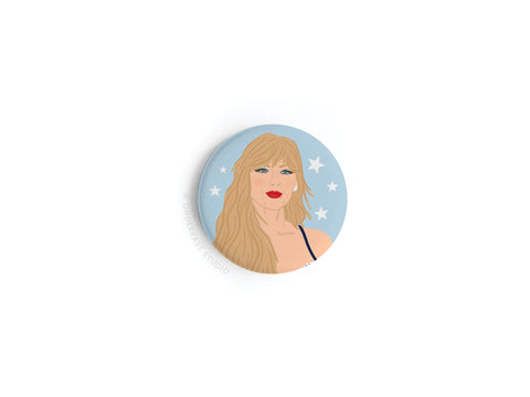 The TS Midnights Button Magnet by Onderkast Studio features a woman with long blonde hair, red lips, and blue eyes on a starry blue background, evoking poetic storytelling and celestial themes.
