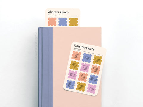 Two pastel books are stacked with a Chapter Chats Book Review Card by Onderkast Studio on top and a matching bookmark. Both feature conversation prompts in flower shapes, printed in the USA.