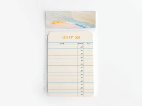 The Onderkast Studio Literary Log Book Review Card Set features cards with columns for title, rating out of 10, and date. Each set includes premium card stock cards with an abstract painting, packaged in a clear sleeve.