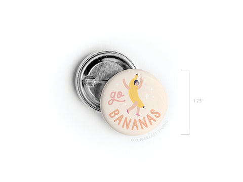 The Go Bananas Pinback Button by Onderkast Studio features a playful banana costume design and fun text. Made in the USA, this 1.25-inch round pin is the perfect way to add quirky flair to your outfit or bag.