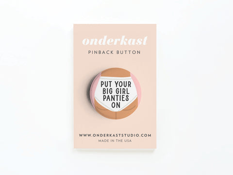 Make a statement with the Put On Your Big Girl Panties Pinback Button by Onderkast Studio, featuring bold text on a beige card and MADE IN THE USA. Find more at www.onderkaststudio.com.