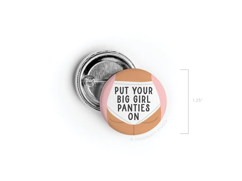 The Put On Your Big Girl Panties Pinback Button by Onderkast Studio features a pink and beige design with empowering text. This 1.25-inch round accessory is a bold statement piece for women.