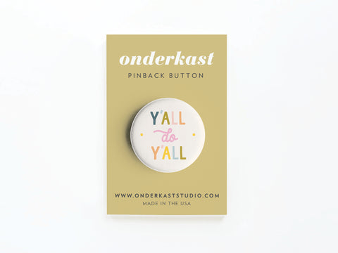 The Y’all Do Y’all Pinback Button by Onderkast Studio is USA-made and comes on a tan card featuring vibrant lettering, onderkast PINBACK BUTTON, the website, and MADE IN THE USA at the bottom, bringing Southern charm to any look.