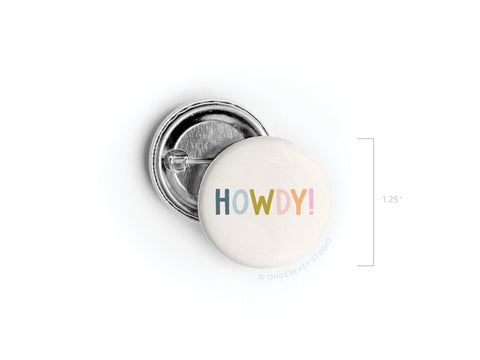 The Howdy! Pinback Button by Onderkast Studio features colorful, playful HOWDY! lettering on white, measures about 1.25 across, and is made in the USA. Shown front and back for detail.