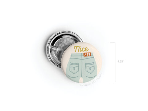 The Nice Ass Pinback Button by Onderkast Studio showcases blue jeans and a playful phrase, celebrating self-love. The button measures 1.25 inches and is perfect for adding a confident touch to your look.