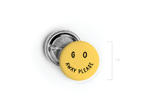 The Go Away Please Pinback Button by Onderkast Studio features a yellow smiley face with GO AWAY PLEASE as the smile. At 1.25 inches, it’s a quirky accessory to show your need for space.