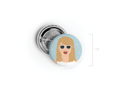 Celebrate pop perfection with the TS 1989 Pinback Button by Onderkast Studio—1.25 round, featuring an illustrated blonde woman in white sunglasses and red lipstick on a light blue, sparkly background.