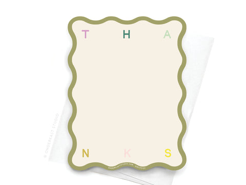 The Thanks Wavy Die Cut Notecard by Onderkast Studio features pastel T, H, A, N, K, S letters on the wavy edges and comes with a white envelope.