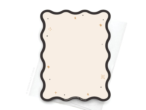 The TS Reputation Wavy Die Cut Notecard by Onderkast Studio features a blank, cream design with a wavy black border and gold star accents, paired with a white envelope—a subtle nod to Taylor Swifts style.
