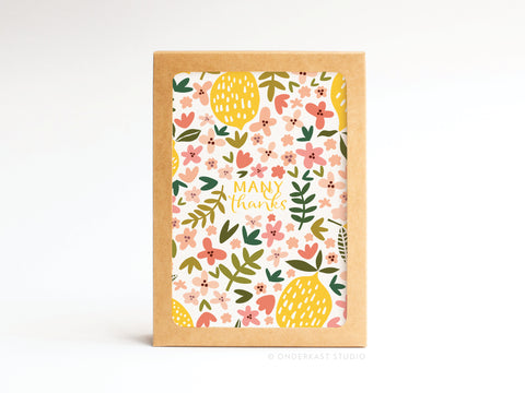 The Onderkast Studio Many Thanks Lemon Floral folded greeting note set of 10 features vibrant pink, yellow, and green floral and leaf designs with “Many thanks” at the center, displayed upright on a plain white background.