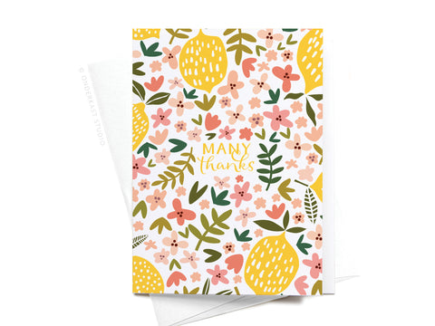 The Onderkast Studio Many Thanks Lemon Floral Folded Greeting Note Set of 10 features bright pink, yellow, green, and white floral patterns with many thanks in yellow script on the front. Includes envelopes.