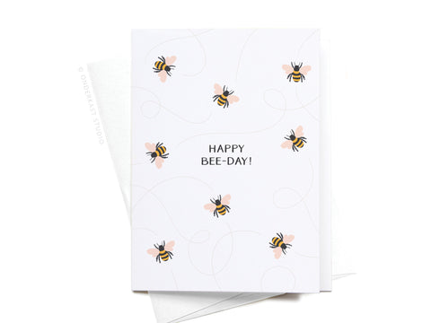 The Happy Bee-day! Folded Greeting Note Set of 10 by Onderkast Studio features cartoon bees and HAPPY BEE-DAY! in vibrant colors on a white card with light curved lines, paired with matching envelopes.