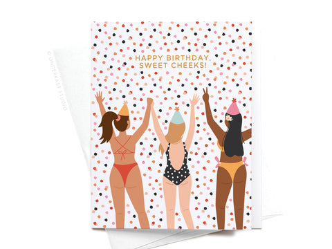 The Happy Birthday Sweet Cheeks Greeting Card by Onderkast Studio features an illustration of three women in swimsuits and party hats with HAPPY BIRTHDAY, SWEET CHEEKS! on a confetti background—fun and premium for any birthday.