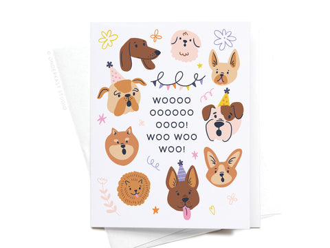 The Woo! Birthday Dogs Greeting Card by Onderkast Studio features cheerful illustrated dog faces, colorful doodles, and playful “WOOOOOOOOO! WOO WOO WOO!” text on a white background with flowers and stars—perfect for dog lovers.