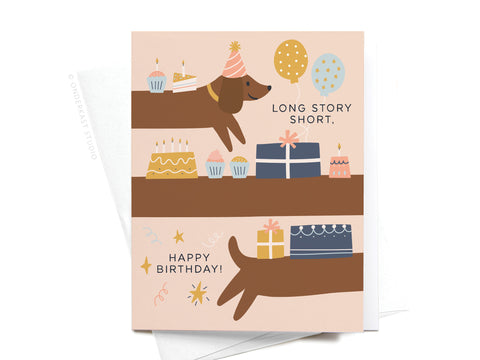 The Long Story Short Dog Birthday Greeting Card by Onderkast Studio features a long brown dachshund in a party hat across two panels with cakes, cupcakes, balloons, and presents. Front reads: Long story short, Happy Birthday!—perfect for dog lovers.