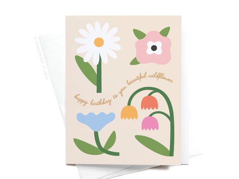 The Happy Birthday to You Beautiful Wildflower Greeting Card by Onderkast Studio features simple, colorful illustrations of four flowers and cursive happy birthday to you, beautiful wildflower, paired with a white envelope.