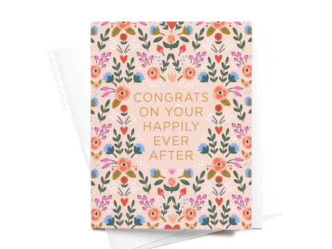 The Onderkast Studio “Congrats on Your Happily Ever After Floral Greeting Card” features a floral design and celebratory message—perfect for weddings—and comes displayed atop a white envelope.