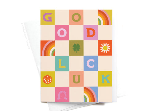 The Groovy Good Luck Greeting Card by Onderkast Studio features bold squares spelling “GOOD LUCK,” each framed by lucky symbols in a playful, retro design for a cheerful and premium feel.