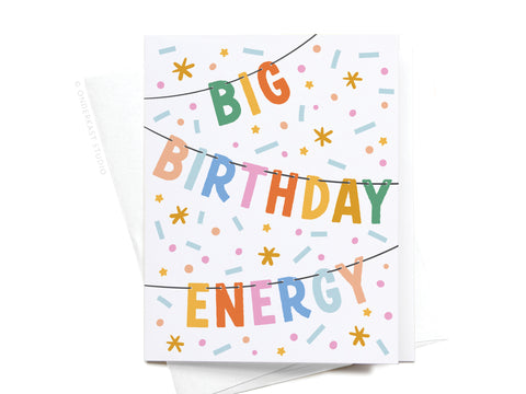The Big Birthday Energy Banner Greeting Card by Onderkast Studio features colorful letters spelling BIG BIRTHDAY ENERGY across three lines, playful confetti shapes in blue, yellow, pink, and orange, and comes with a white envelope.
