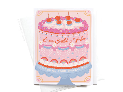 The Sweet Birthday Wishes Retro Cake Greeting Card by Onderkast Studio features a pink cake with cherries, rainbow details, and “Sweet Birthday Wishes” text. Comes with a white envelope.