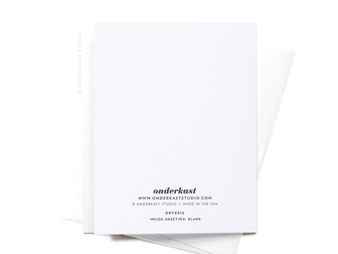 The Strut Into Your Best Year Ostrich Greeting Card by Onderkast Studio is shown with its back up, displaying the logo, website, and product details in black. Ideal for birthdays or milestone celebrations, it sits atop a white envelope.