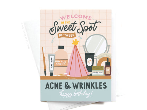 The Sweet Spot Between Acne & Wrinkles Greeting Card by Onderkast Studio features skincare illustrations, a party hat, and a mirror. Front text: Welcome to the Sweet Spot Between Acne & Wrinkles. Happy Birthday!.