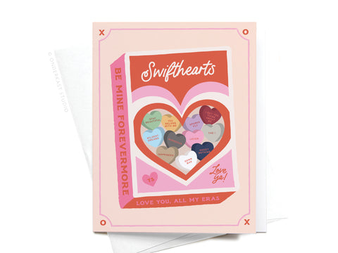 Onderkast Studio’s Swifthearts Candy Box Greeting Card features heart-shaped candies inspired by Taylors eras and sweet messages: “Be mine forevermore” and “Love you. All my eras.” A perfect Valentine for devoted Swifties.