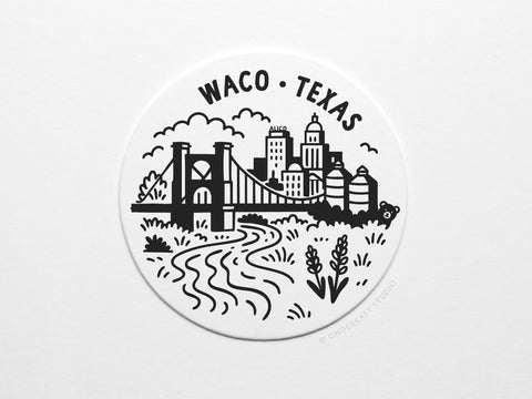 The Waco Texas Skyline Letterpress Coaster Set by Onderkast Studio features a black and white cityscape with Waco Texas above the skyline, bridge, silos, river, clouds, and foreground plants.