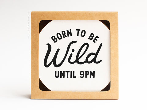 The Onderkast Studio Born To Be Wild Until 9pm Letterpress Coaster Set features bold black text on white coasters, packaged in a recyclable kraft box.