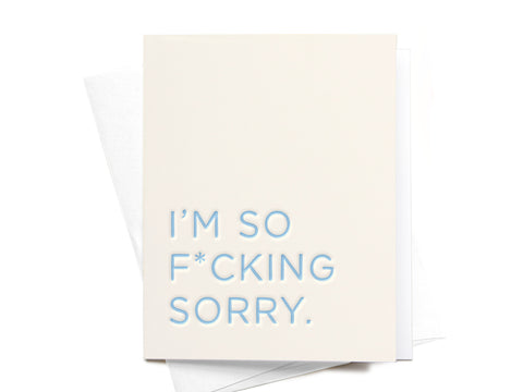 The I’m So F*cking Sorry Letterpress Greeting Card by Onderkast Studio features a cream color and light blue uppercase text, offering a premium feel. The card is shown atop a white envelope.