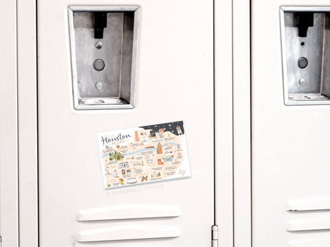 A white metal locker decorated with the Onderkast Studio Houston Map Refrigerator Magnet, featuring illustrated landmarks and notes for a colorful Texas souvenir accent.