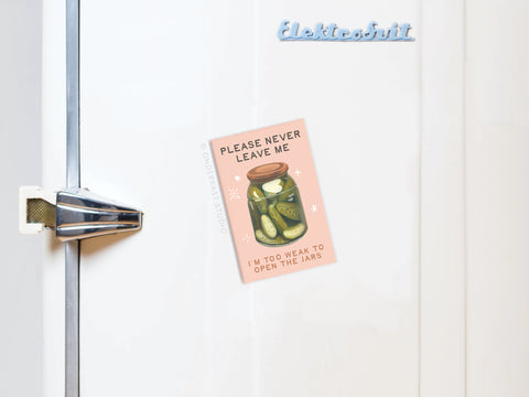 The Never Leave Me Pickles Jar Refrigerator Magnet by Onderkast Studio is perfect for pickle lovers, featuring the message: “Please never leave me. I’m too weak to open the jars.”.
