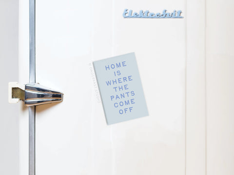 A white fridge with a silver handle displays the Onderkast Studio Home Is Where the Pants Come Off Refrigerator Magnet—a fun way to add personality and humor to your home decor.