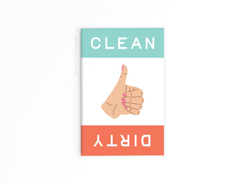 The Onderkast Studio Dirty Clean Thumbs Up/Down Dishwasher Refrigerator Magnet features a central thumbs-up illustration with CLEAN in teal at the top and DIRTY on red at the bottom—making kitchen routines simple and clear.