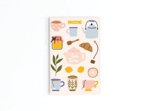 Add a charming touch to your kitchen with the Tea Time Refrigerator Magnet by Onderkast Studio, featuring illustrated tea time items like cups, a teapot labeled Tea Time, a croissant, lemons, honey jar, sugar packet, coffee pot, and plant.