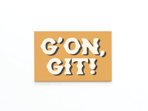 A rectangular, mustard yellow Onderkast Studio magnet features bold white GON, GIT! text in a playful, shadowed font, capturing rustic character and Southern charm—just like the classic G’on Git Refrigerator Magnet.