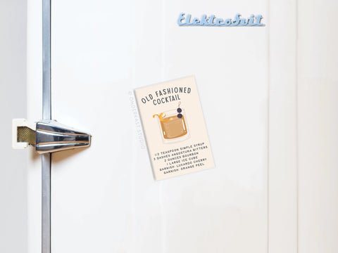 A white fridge with a retro handle and Elektrosvit logo showcases Onderkast Studio’s Old Fashioned Cocktail Recipe Refrigerator Magnet, featuring an illustrated recipe card for the classic drink to enhance your mixology skills.